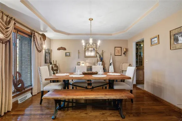 a view of a dining room with furniture and wooden floor