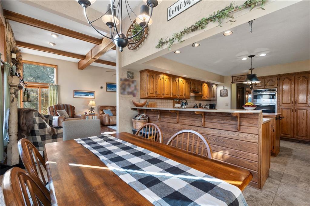 338 Quarry Road Washington, PA 15301 - Photo 29 of 50 a kitchen with stainless steel appliances granite countertop a stove a sink dishwasher a dining table and chairs with wooden floor