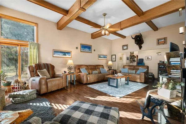 a living room with furniture a chandelier and a large window