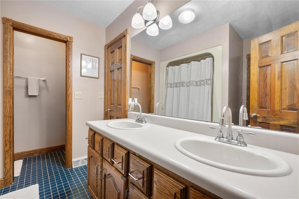338 Quarry Road Washington, PA 15301 - Photo 35 of 50 a bathroom with a double vanity sink and a mirror