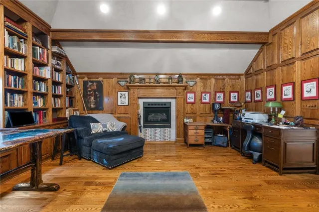 a living room with furniture a fireplace and bookshelf