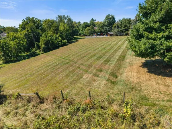a view of a field with an ocean view