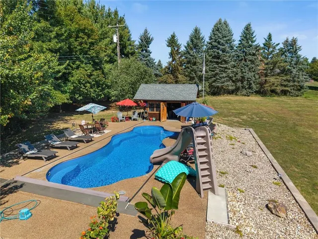 swimming pool view with a seating space