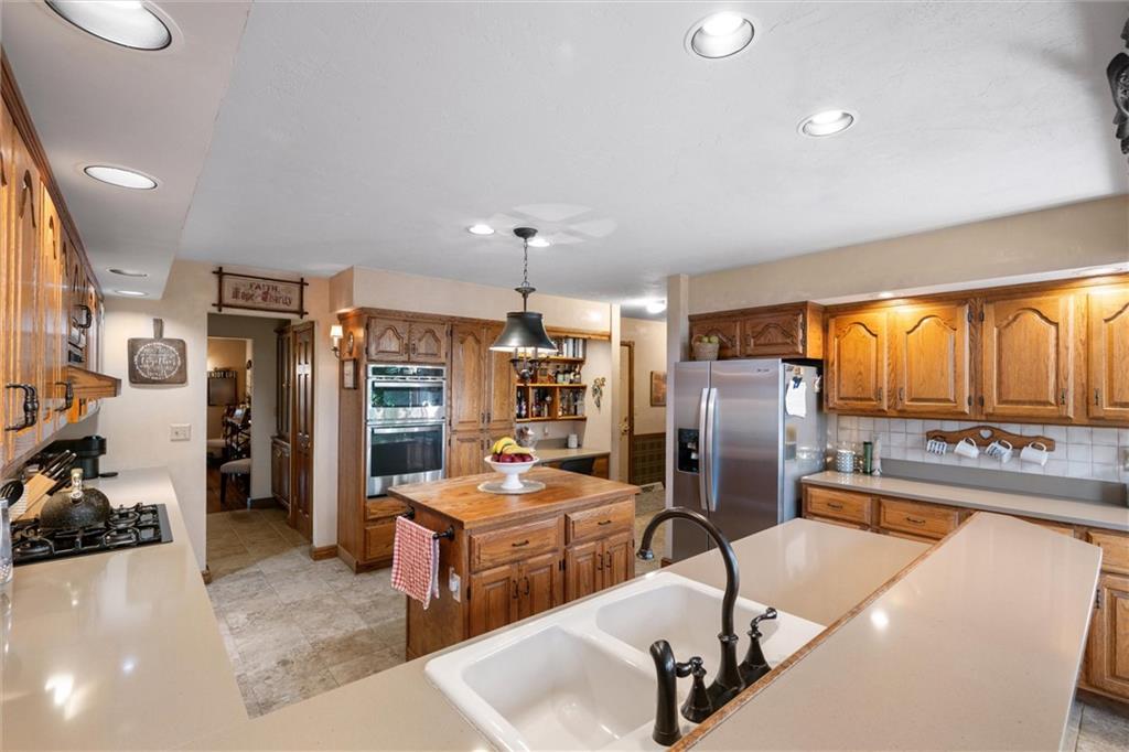 338 Quarry Road Washington, PA 15301 - Photo 5 of 50 a kitchen with stainless steel appliances kitchen island granite countertop a refrigerator and a stove top oven
