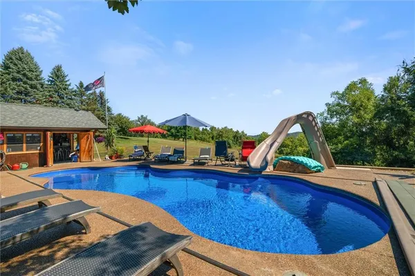 a view of a swimming pool with lounge chairs
