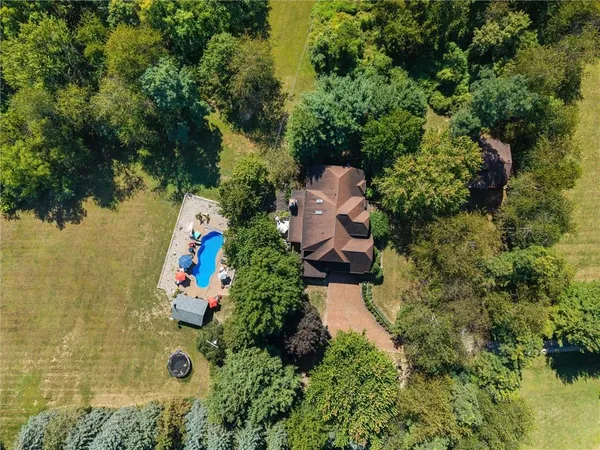 an aerial view of a house with a yard