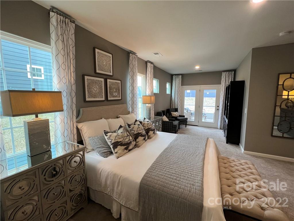 4027 Havenport Circle, Unit 121 Tega Cay, SC 29708 - Photo 11 of 24 a bedroom with a bed and wooden floor