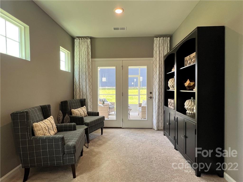 4027 Havenport Circle, Unit 121 Tega Cay, SC 29708 - Photo 12 of 24 a living room with furniture and a large window