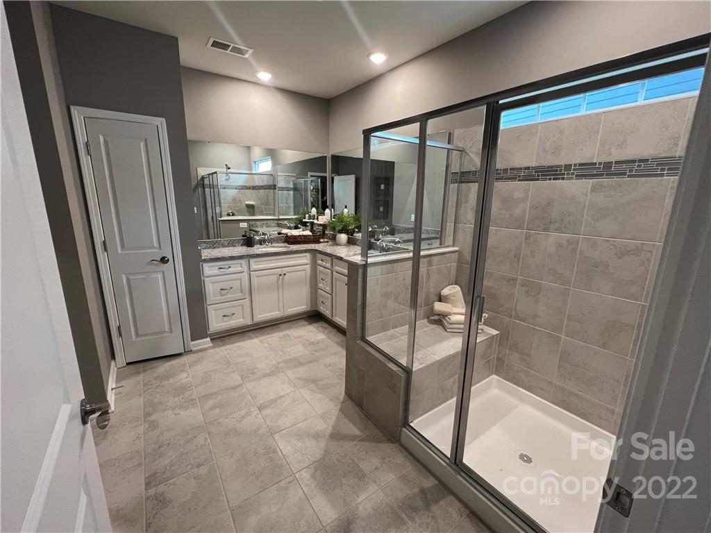 4027 Havenport Circle, Unit 121 Tega Cay, SC 29708 - Photo 14 of 24 a kitchen with stainless steel appliances a refrigerator and white cabinets
