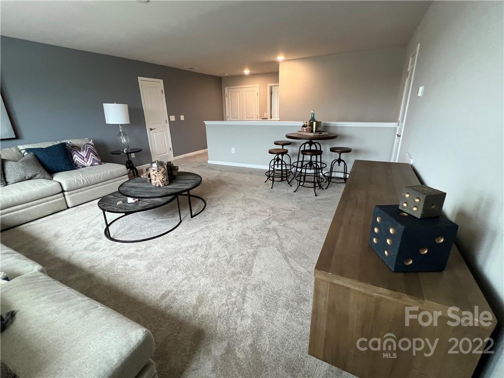 4027 Havenport Circle, Unit 121 Tega Cay, SC 29708 - Photo 20 of 24 a living room with furniture and a table