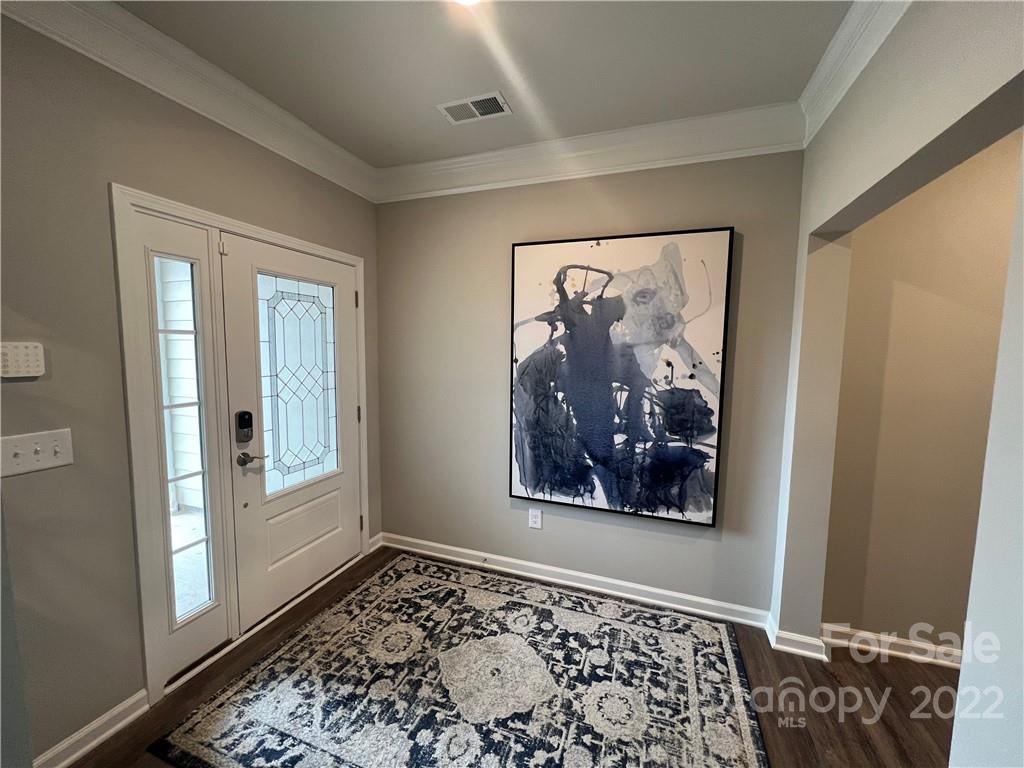4027 Havenport Circle, Unit 121 Tega Cay, SC 29708 - Photo 2 of 24 a view of a hallway with wooden floor and a bedroom