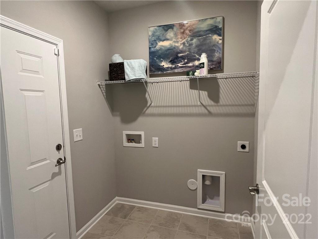 4027 Havenport Circle, Unit 121 Tega Cay, SC 29708 - Photo 21 of 24 a close view of a utility room with dryer and washer