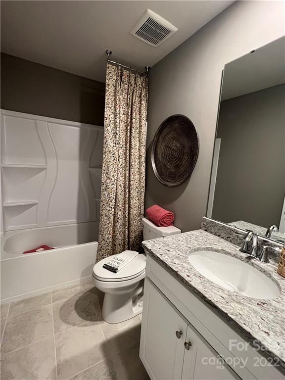 4027 Havenport Circle, Unit 121 Tega Cay, SC 29708 - Photo 24 of 24 a bathroom with a granite countertop toilet sink and mirror