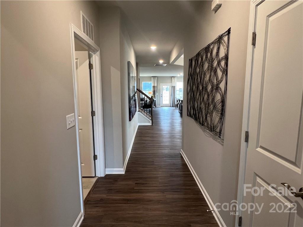 4027 Havenport Circle, Unit 121 Tega Cay, SC 29708 - Photo 3 of 24 a view of a hallway with wooden floor and stairs
