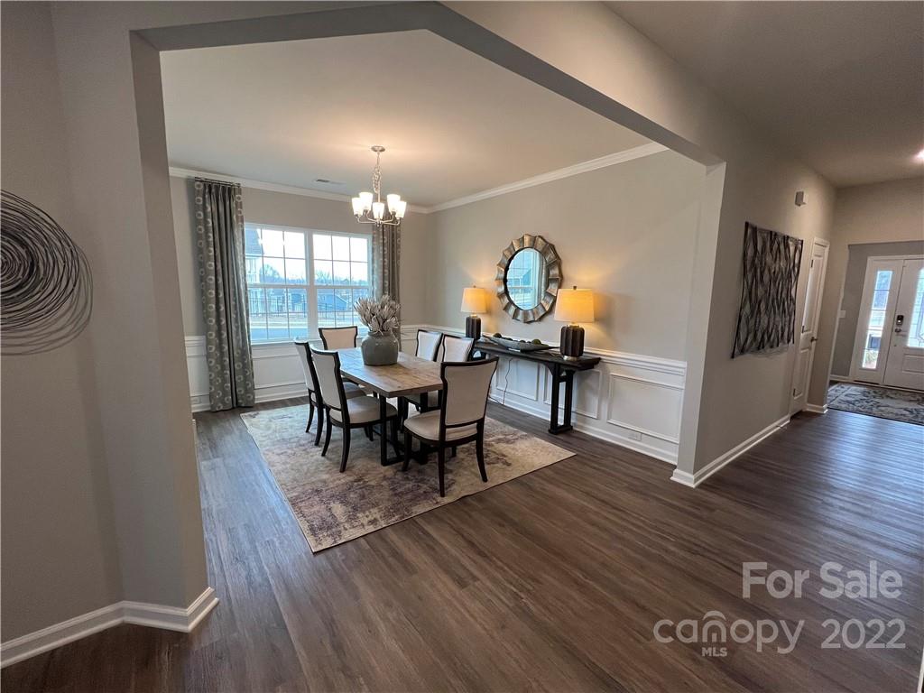 4027 Havenport Circle, Unit 121 Tega Cay, SC 29708 - Photo 4 of 24 a view of a dining room with furniture and wooden floor