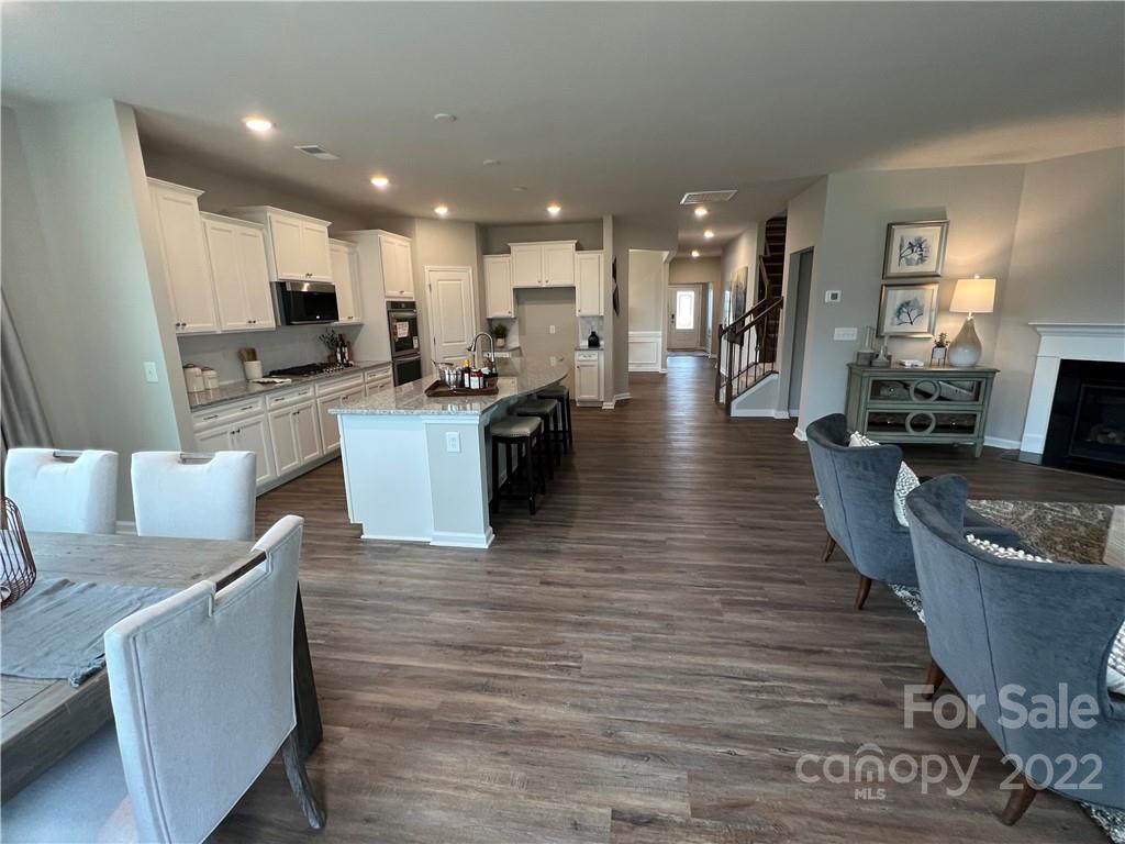 4027 Havenport Circle, Unit 121 Tega Cay, SC 29708 - Photo 7 of 24 a living room with furniture wooden floor and a kitchen view