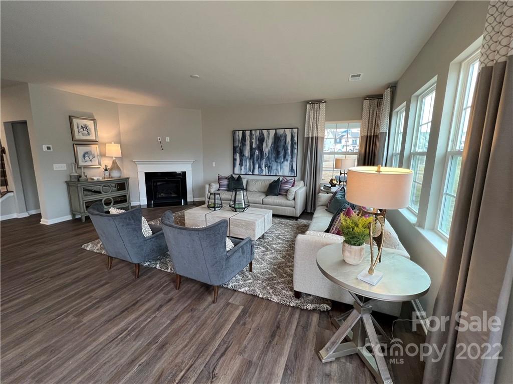 4027 Havenport Circle, Unit 121 Tega Cay, SC 29708 - Photo 9 of 24 a living room with furniture and a wooden floor