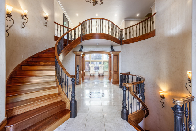 694 West Cephus Road Draper, UT 84020 - Photo 10 of 148 Grand curved staircase with rich wood-finish treads and balusters, wrought iron spindles, and a matching upper landing