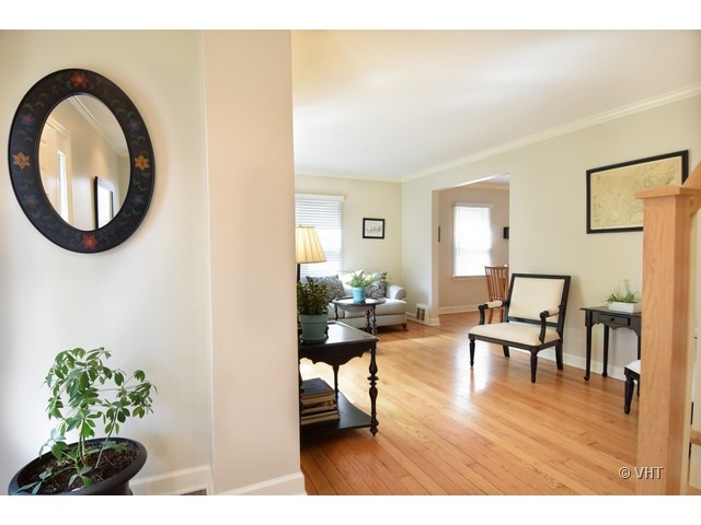 924 Spring Road Elmhurst, IL 60126 - Photo 2 of 18 a living room with furniture a dining table and a wooden floor
