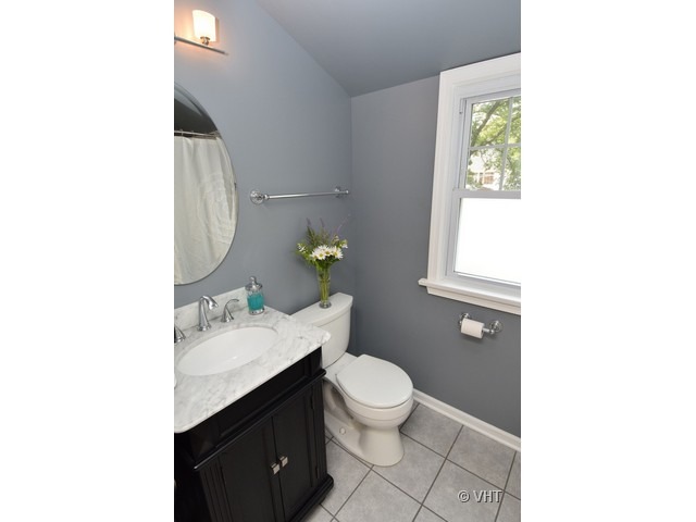 924 Spring Road Elmhurst, IL 60126 - Photo 13 of 18 a bathroom with a sink toilet and window