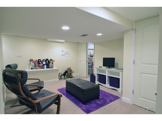 924 Spring Road Elmhurst, IL 60126 - Photo 15 of 18 a living room with furniture and a flat screen tv