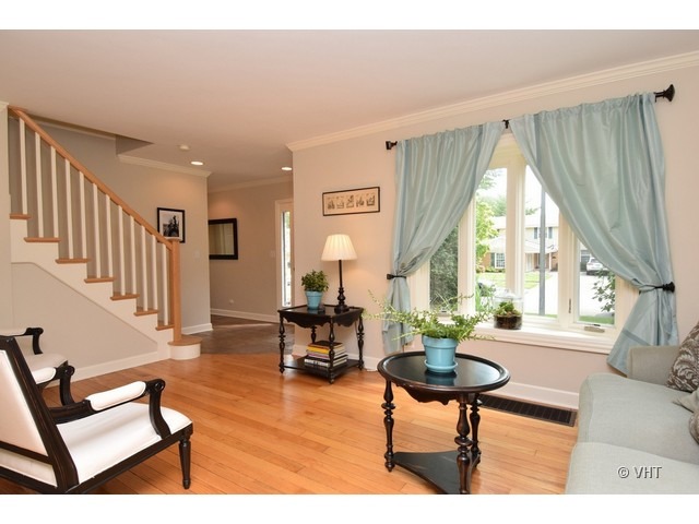 924 Spring Road Elmhurst, IL 60126 - Photo 3 of 18 a living room with furniture a table and large windows