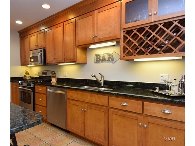 924 Spring Road Elmhurst, IL 60126 - Photo 6 of 18 a kitchen with stainless steel appliances granite countertop a sink a stove and cabinets