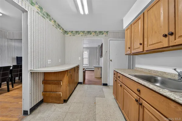 a kitchen with granite countertop a sink and cabinets