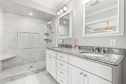 a bathroom with a granite countertop sink mirror and