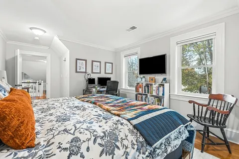 a bed room with a bed and a television