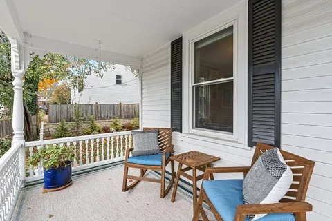 a view of a chairs and table in the balcony