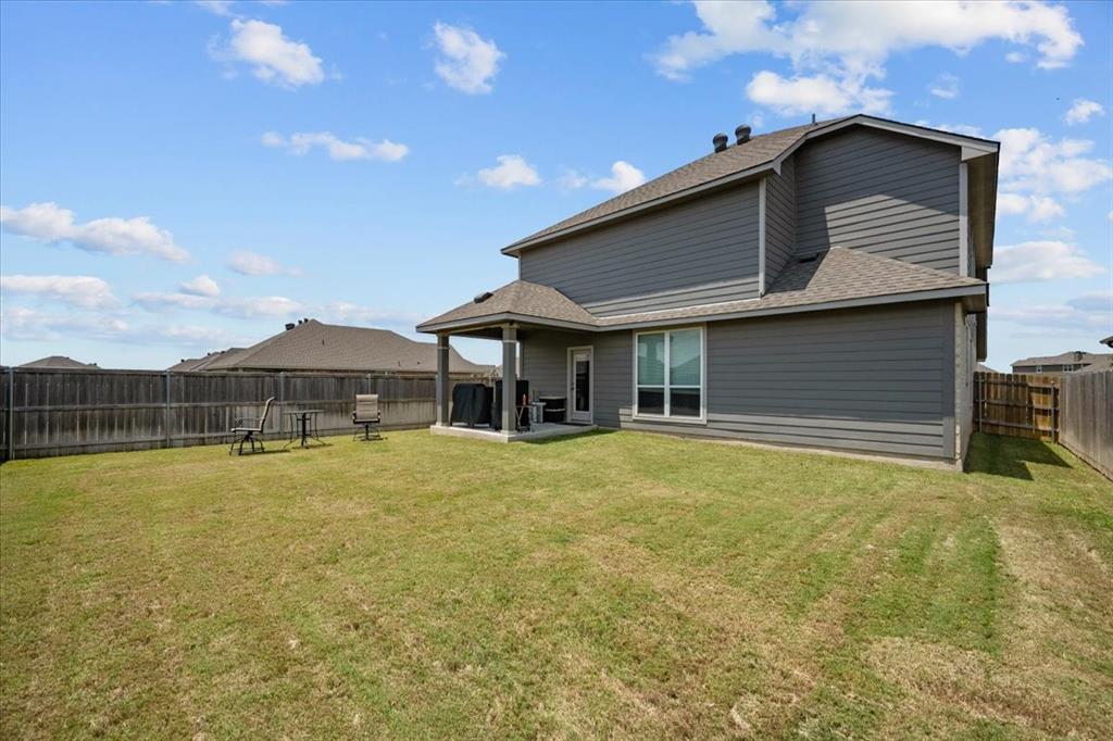 3501 Beutel Road Lorena, TX 76655 - Photo 32 of 33 Back of house with roof with shingles, a fenced backyard, and a patio area