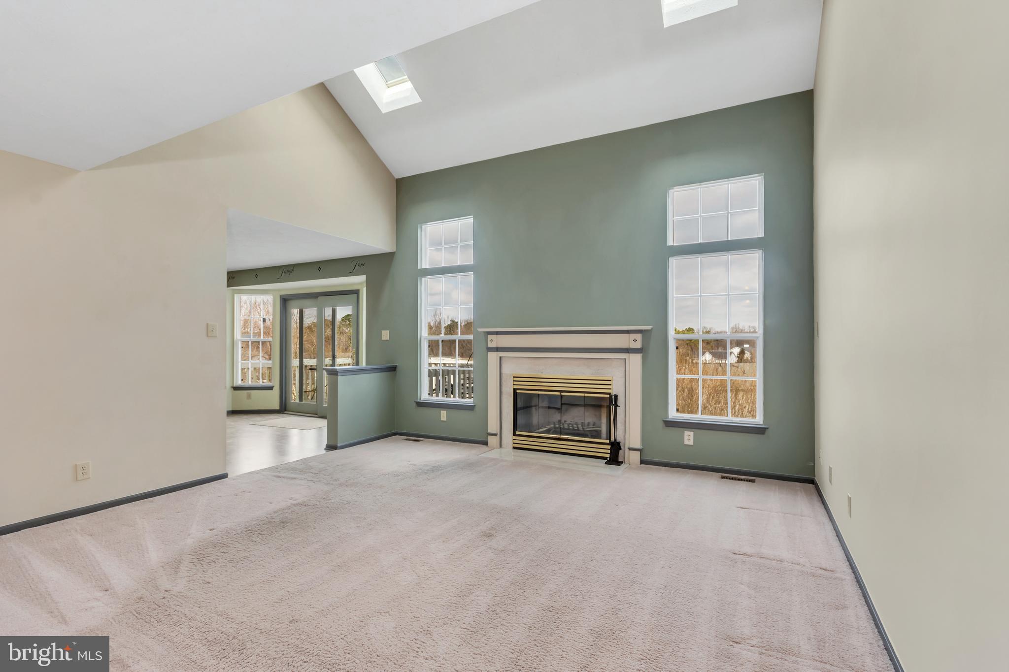2908 Garwood Road Sicklerville, NJ 08081 - Photo 5 of 25 a view of an empty room with a fireplace and a window