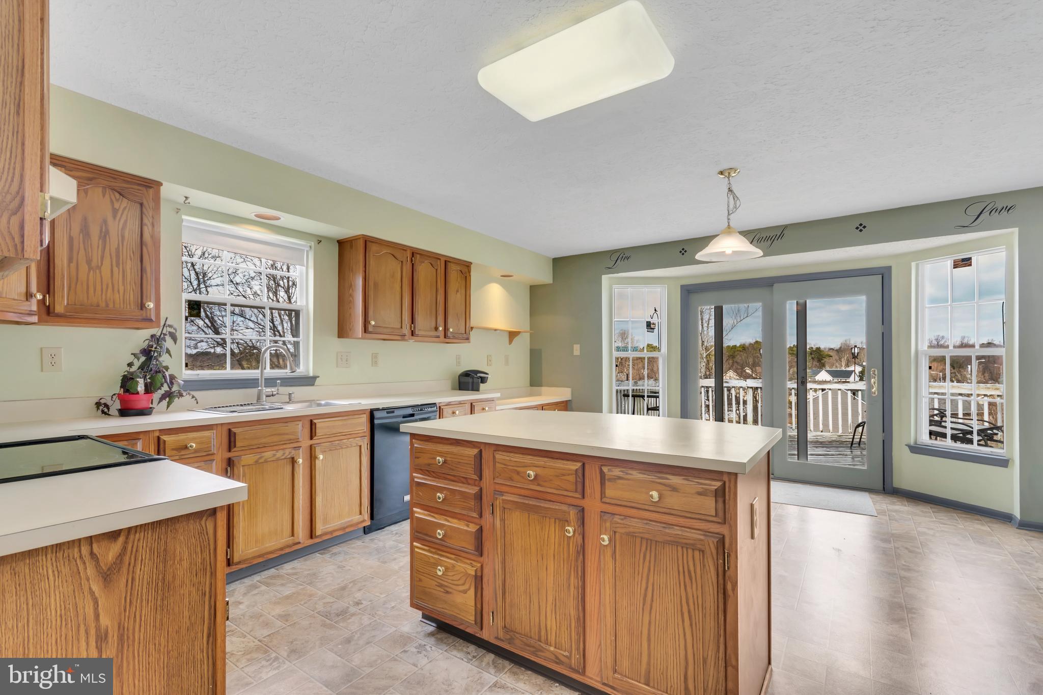 2908 Garwood Road Sicklerville, NJ 08081 - Photo 7 of 25 a large kitchen with kitchen island granite countertop a large window a sink and stainless steel appliances
