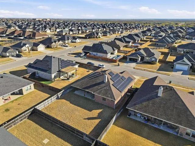 an aerial view of residential houses with outdoor space