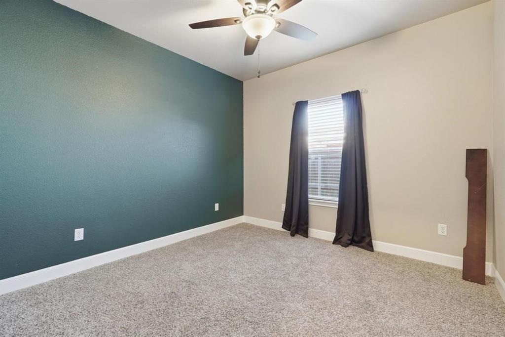 7414 Morning Glory Road Abilene, TX 79602 - Photo 18 of 34 an empty room with a ceiling fan and a window