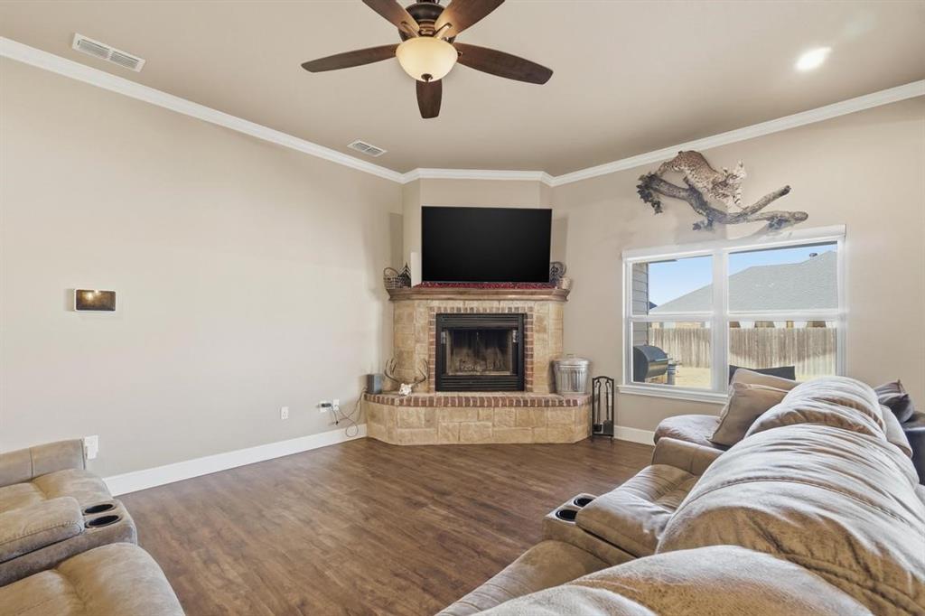 7414 Morning Glory Road Abilene, TX 79602 - Photo 29 of 34 a living room with furniture a flat screen tv and a fireplace