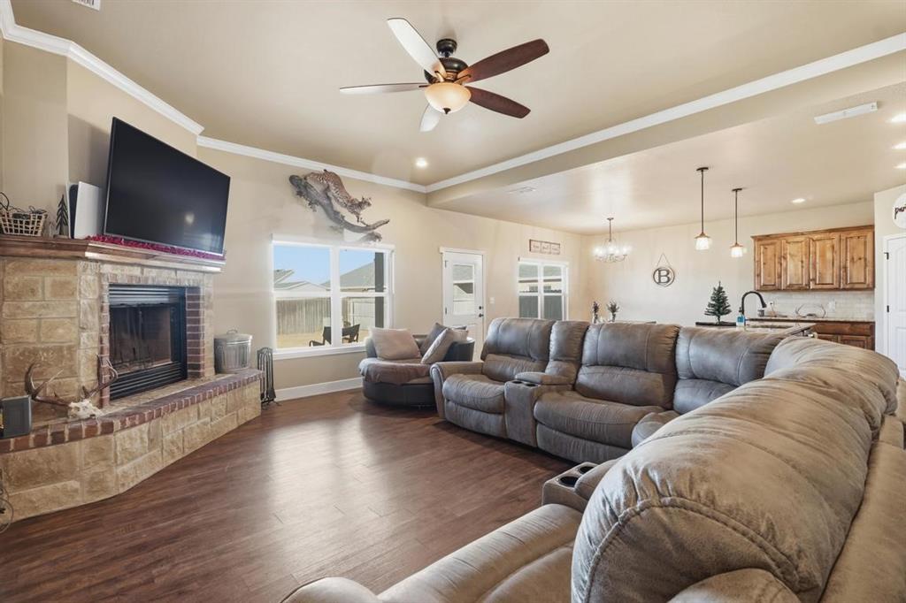 7414 Morning Glory Road Abilene, TX 79602 - Photo 31 of 34 a living room with furniture kitchen view and a fireplace