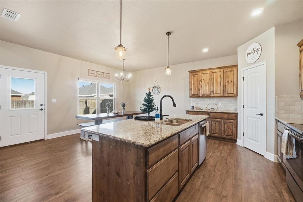 7414 Morning Glory Road Abilene, TX 79602 - Photo 32 of 34 a kitchen with sink stove and wooden floor