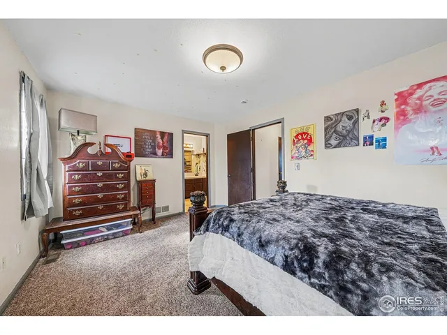 a bedroom with a bed and a desk