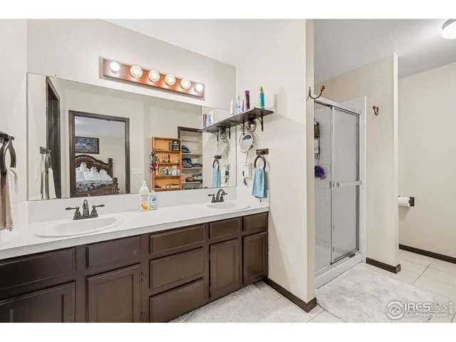 a bathroom with a sink vanity mirror and shower