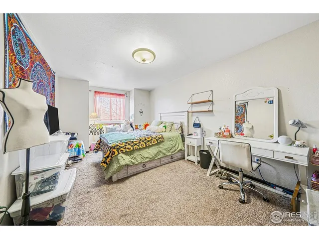 a bedroom with furniture and a wooden floor