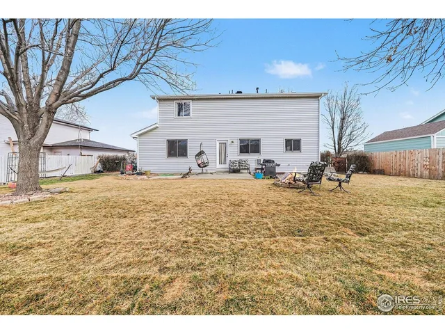a view of a house with a yard covered in snow