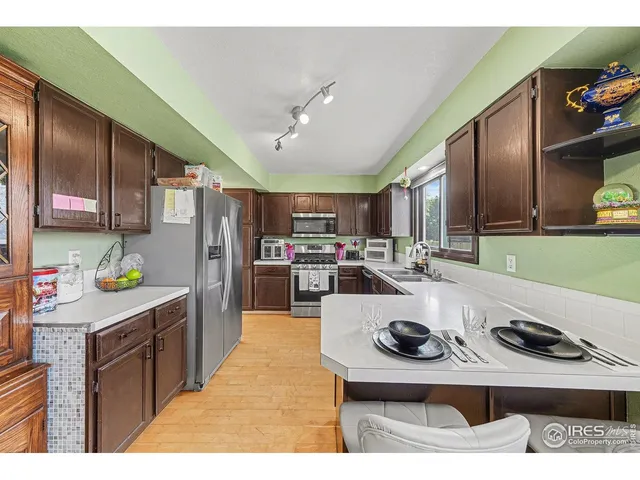 a kitchen with refrigerator and cabinets
