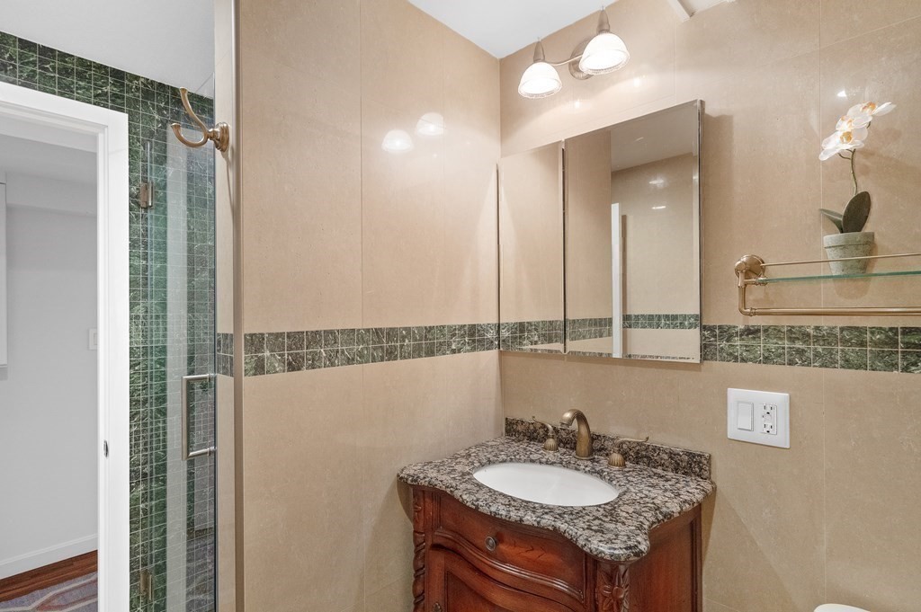 113 Deborah Road Newton, MA 02459 - Photo 31 of 34 a bathroom with a granite countertop sink and a mirror