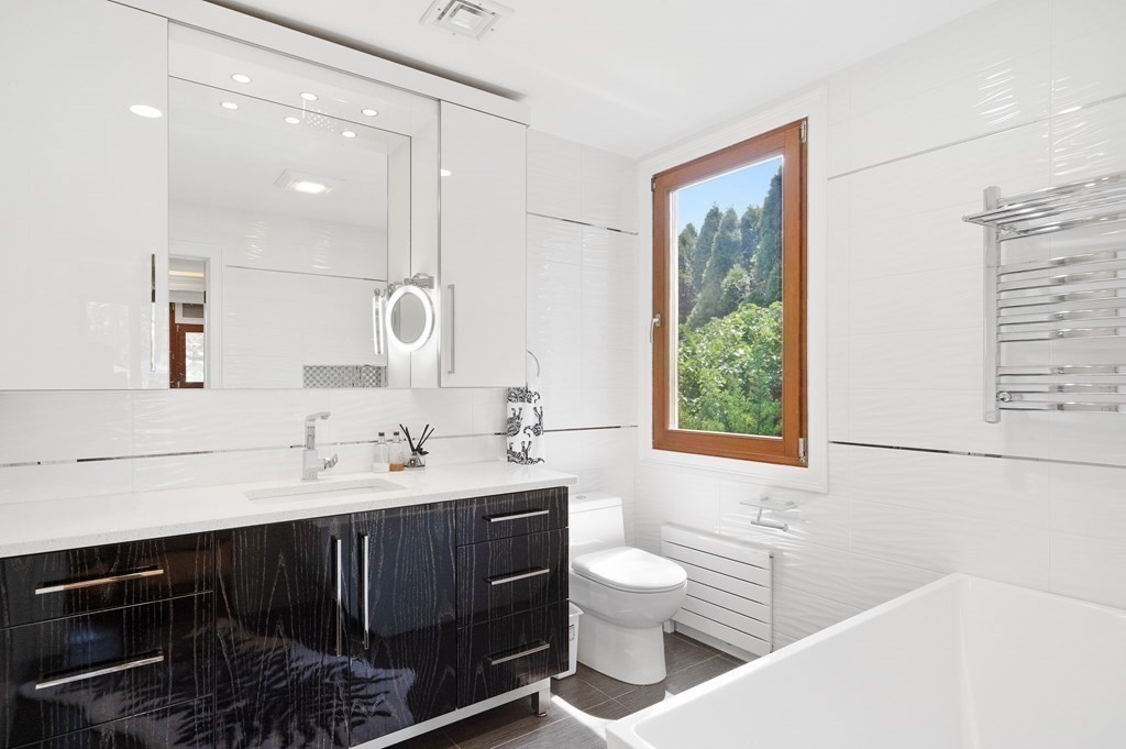 113 Deborah Road Newton, MA 02459 - Photo 33 of 34 a bathroom with a toilet sink and mirror