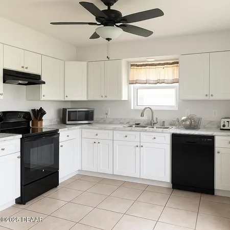 a kitchen with granite countertop cabinets stainless steel appliances and a sink