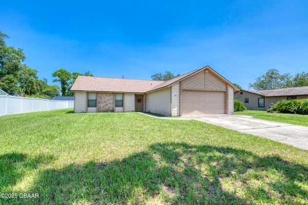 a front view of house with yard and green space