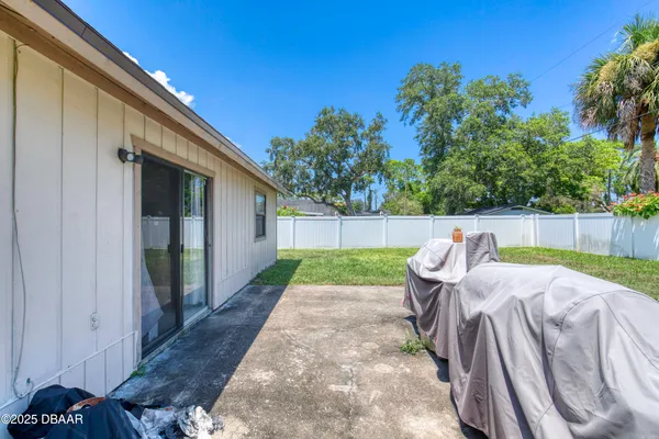 a view of backyard with patio