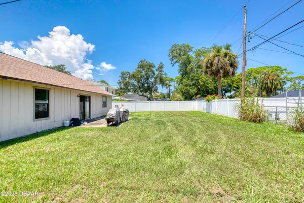 a view of a backyard with plants and a patio